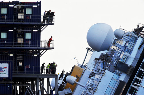 Standing on platforms, the workers looked on as they prepared to right Costa Concordia.
Standing on platforms, the workers looked on as they prepared to right Costa Concordia.