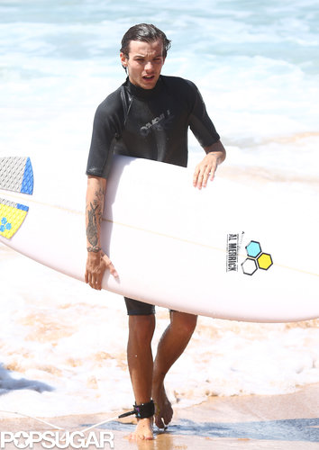 Louis Tomlinson carried his surfboard after taking a dip in the ocean.
Louis Tomlinson carried his surfboard after taking a dip in the ocean.