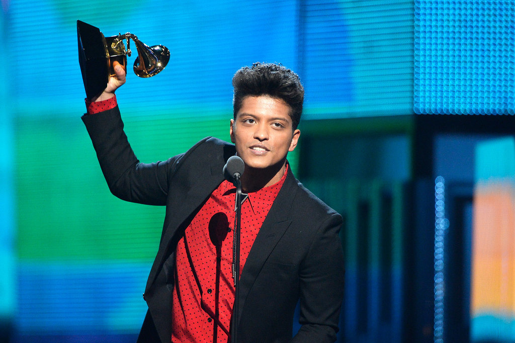 Bruno Mars accepted his award by hoisting it in the air.
Bruno Mars accepted his award by hoisting it in the air.