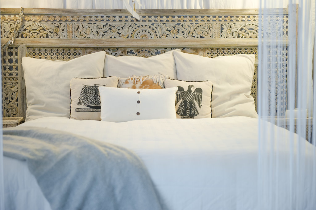 Tucked away in the upper level of her loft, crisp linens and an intricate headboard hide under a white canopy.
Photo by Ashley Camper
Tucked away in the upper level of her loft, crisp linens and an intricate headboard hide under a white canopy.
Photo by Ashley Camper