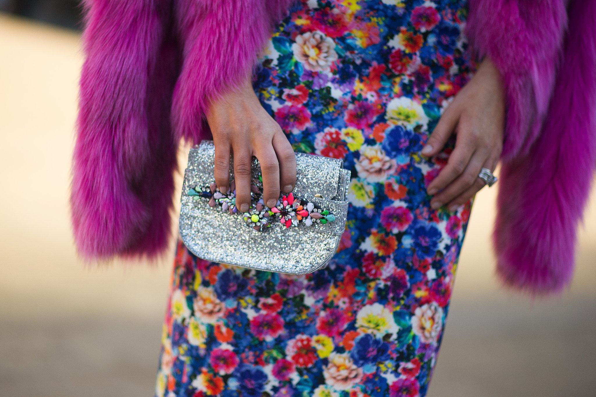 The multicolored embellishments on her clutch upped the ante on her rainbow-bright floral print. 
