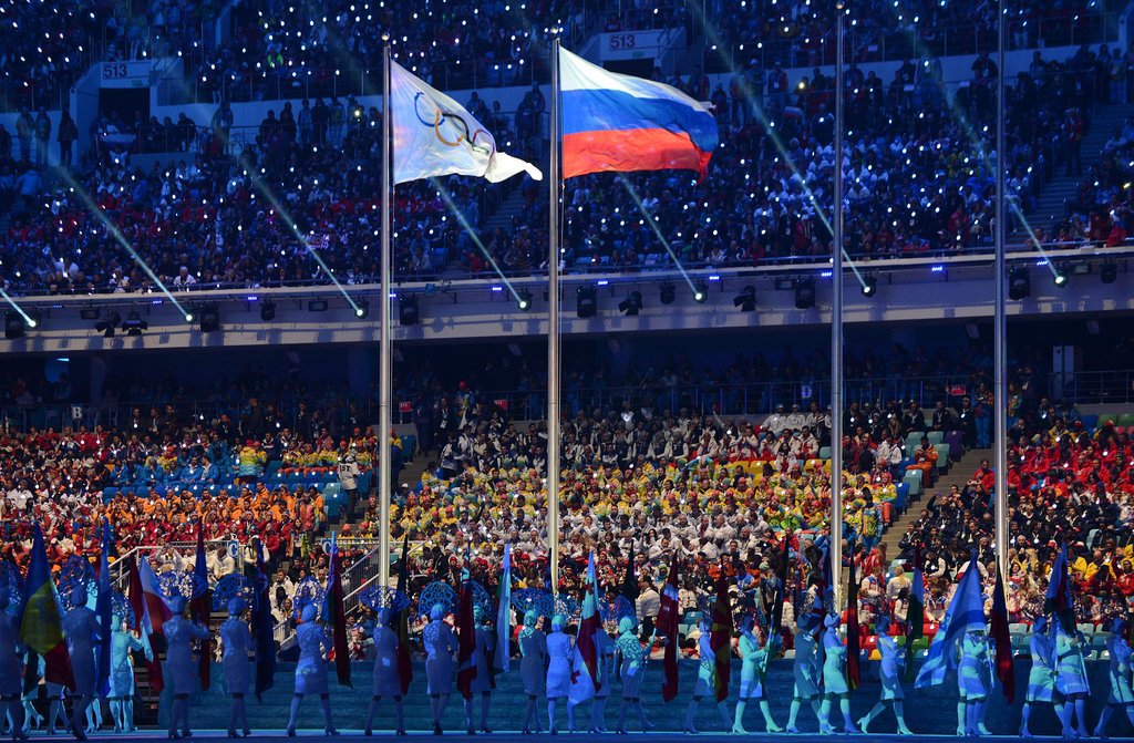 The Russian flag waved beside the Olympic flag.
