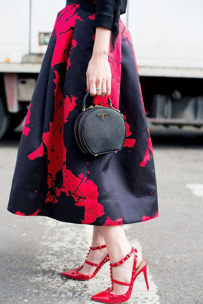 When you wear a ladylike skirt, like this one from Tibi, it's always wise to add ladylike accoutrements, like her top-handle Prada bag and Valentino heels.
When you wear a ladylike skirt, like this one from Tibi, it's always wise to add ladylike accoutrements, like her top-handle Prada bag and Valentino heels.