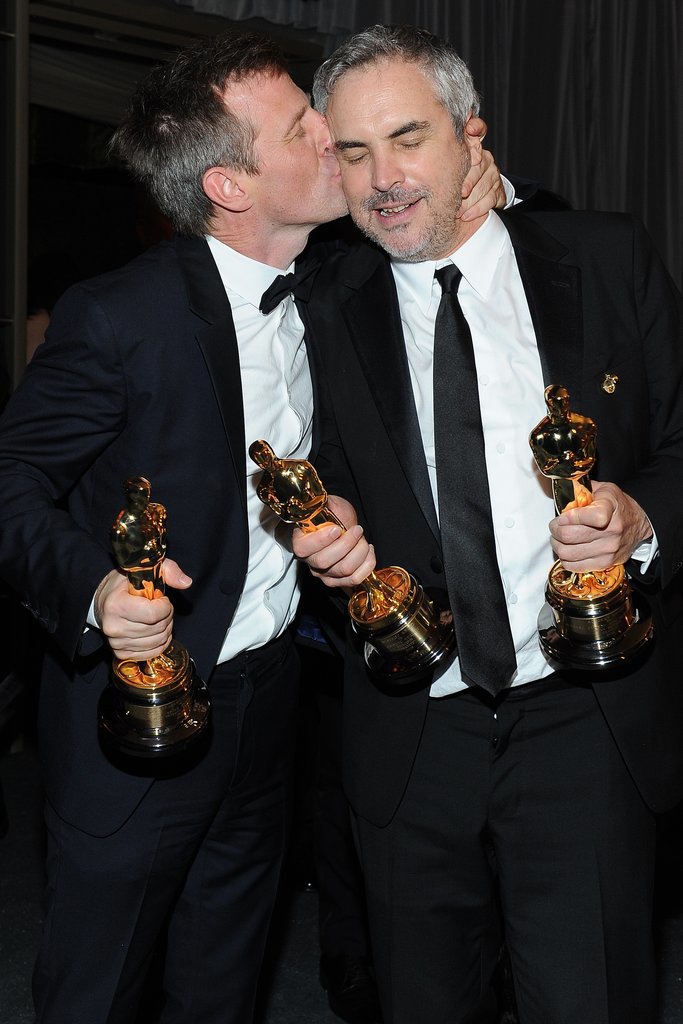 Spike Jonze, who won the Oscar for best original screenplay for Her, planted one on best director winner for Gravity Alfonso Cuarón.
Spike Jonze, who won the Oscar for best original screenplay for Her, planted one on best director winner for Gravity Alfonso Cuarón.