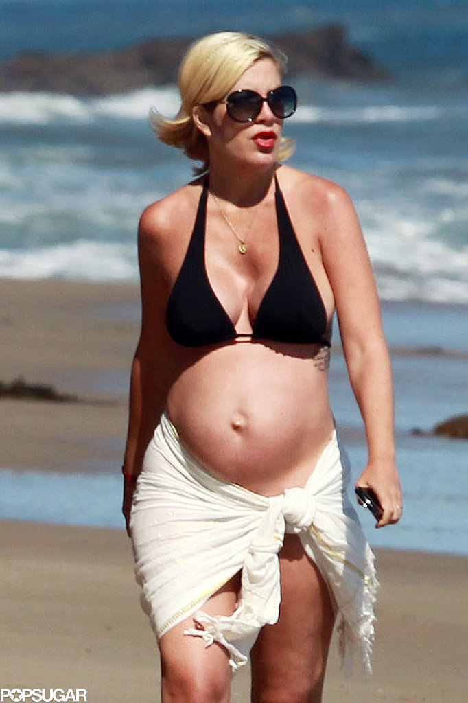 Tori Spelling was spotted taking a walk on the beach with her family while pregnant with baby Hattie. The now mama of four has said she's proud to show off her baby belly in a bikini.
Tori Spelling was spotted taking a walk on the beach with her family while pregnant with baby Hattie. The now mama of four has said she's proud to show off her baby belly in a bikini.