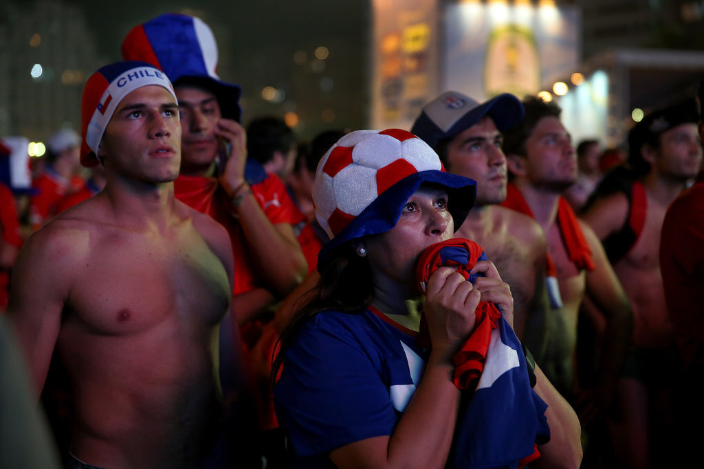 Chilean soccer fans watched their team play on a giant screen at Copacabana Beach in Brazil.
Chilean soccer fans watched their team play on a giant screen at Copacabana Beach in Brazil.