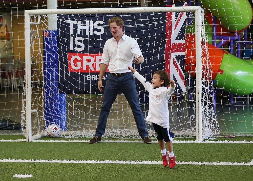 Prince Harry played soccer with a young boy during his tour of Brazil on Tuesday.
Prince Harry played soccer with a young boy during his tour of Brazil on Tuesday.