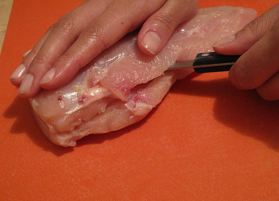 Cut the larger chicken breast piece in half crosswise.