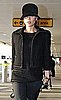 Victoria Beckham in Black Tweed Jacket and Hat at Heathrow Airport in London