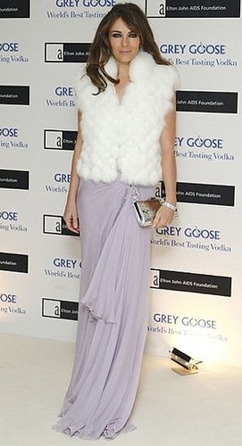 Photo of Elizabeth Hurley Wearing Lavender Dress and White Fur Vest at Grey Goose Vodka Fundraiser in London