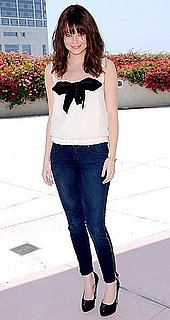 Actress Emma Stone in Zippered Jeans and Bow Blouse at Comic Con