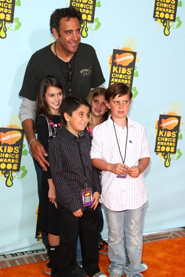 Brad Garrett had lots of lil company on the orange carpet. Brad Garrett had lots of lil company on the orange carpet.
