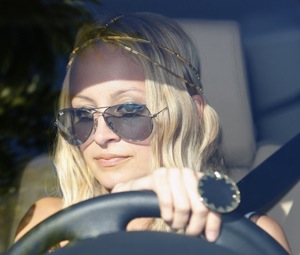 Nicole Richie Driving Wearing a Ring From Her Mysterious Jewelry Line House of Harlow 1960