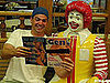 Man Poses With Ronald McDonald and Porn