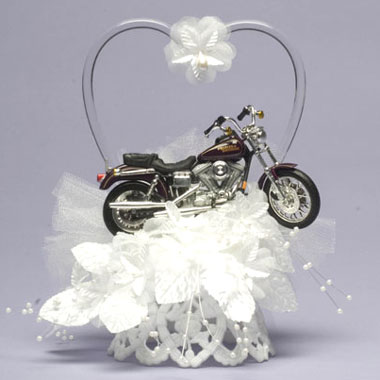 Maybe the lace represents one of you, and the motorcycle the other, but I think this motorcycle wedding cake topper ($46.95) is downright tacky. It's not so much that it's a motorcycle, it's that it's a motorcycle in a field of lace. If you're both into motorcycles, get a groom's cake shaped in a motorcycle, or just go for a motorcycle-couple topper and quit trying to combine elegance and motorcycle at the same time.
Maybe the lace represents one of you, and the motorcycle the other, but I think this motorcycle wedding cake topper ($46.95) is downright tacky. It's not so much that it's a motorcycle, it's that it's a motorcycle in a field of lace. If you're both into motorcycles, get a groom's cake shaped in a motorcycle, or just go for a motorcycle-couple topper and quit trying to combine elegance and motorcycle at the same time.