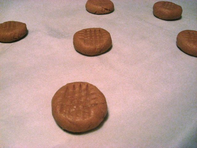 Set the rounded ball of dough on the cookie sheet and use a flat-bottomed glass to smoosh it out a bit. Set the rounded ball of dough on the cookie sheet and use a flat-bottomed glass to smoosh it out a bit.