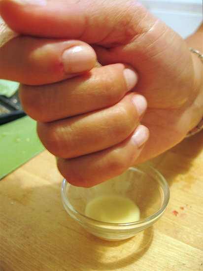 Squeezing the grated ginger Squeezing the grated ginger