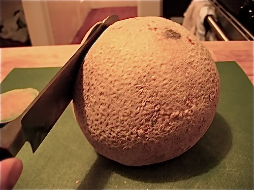 Select sturdy, heavy, fragrant melons. Begin by using a chef's knife to slice off the end of the cantaloupe where the stem is, so that this end of the cantaloupe is now flat. Sit the spherical melon on the flat side and carefully turn the cantaloupe, shaving off the outer shell in vertical strips with the knife.
Select sturdy, heavy, fragrant melons. Begin by using a chef's knife to slice off the end of the cantaloupe where the stem is, so that this end of the cantaloupe is now flat. Sit the spherical melon on the flat side and carefully turn the cantaloupe, shaving off the outer shell in vertical strips with the knife.