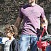 Hugh Flexes His Biceps While Carrying Kiddie Bags