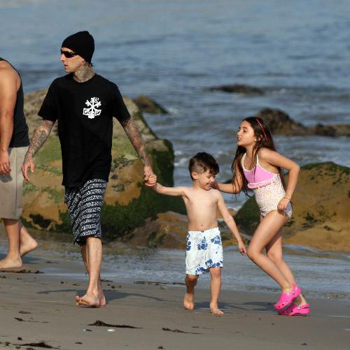 Down in Malibu, Travis Barker took his kids, Landon and Atiana out in the surf. Down in Malibu, Travis Barker took his kids, Landon and Atiana out in the surf.