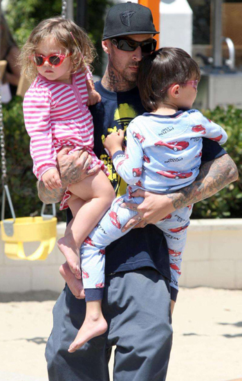 Travis Barker toted his tots around the playground. Travis Barker toted his tots around the playground.
