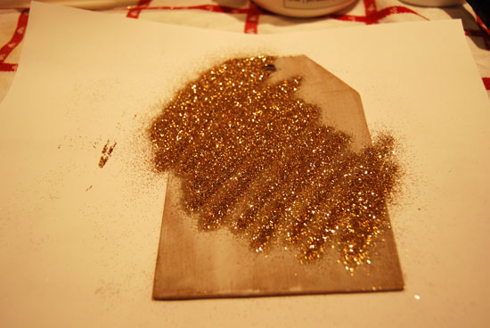Sprinkling the glitter on the glue surface Sprinkling the glitter on the glue surface