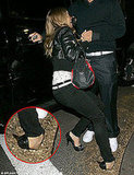 Fall from grace: Fergie trips over in her towering heels