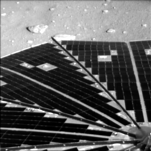 Here, the Phoenix Mars Lander's solar arrays are seen. Here, the Phoenix Mars Lander's solar arrays are seen.