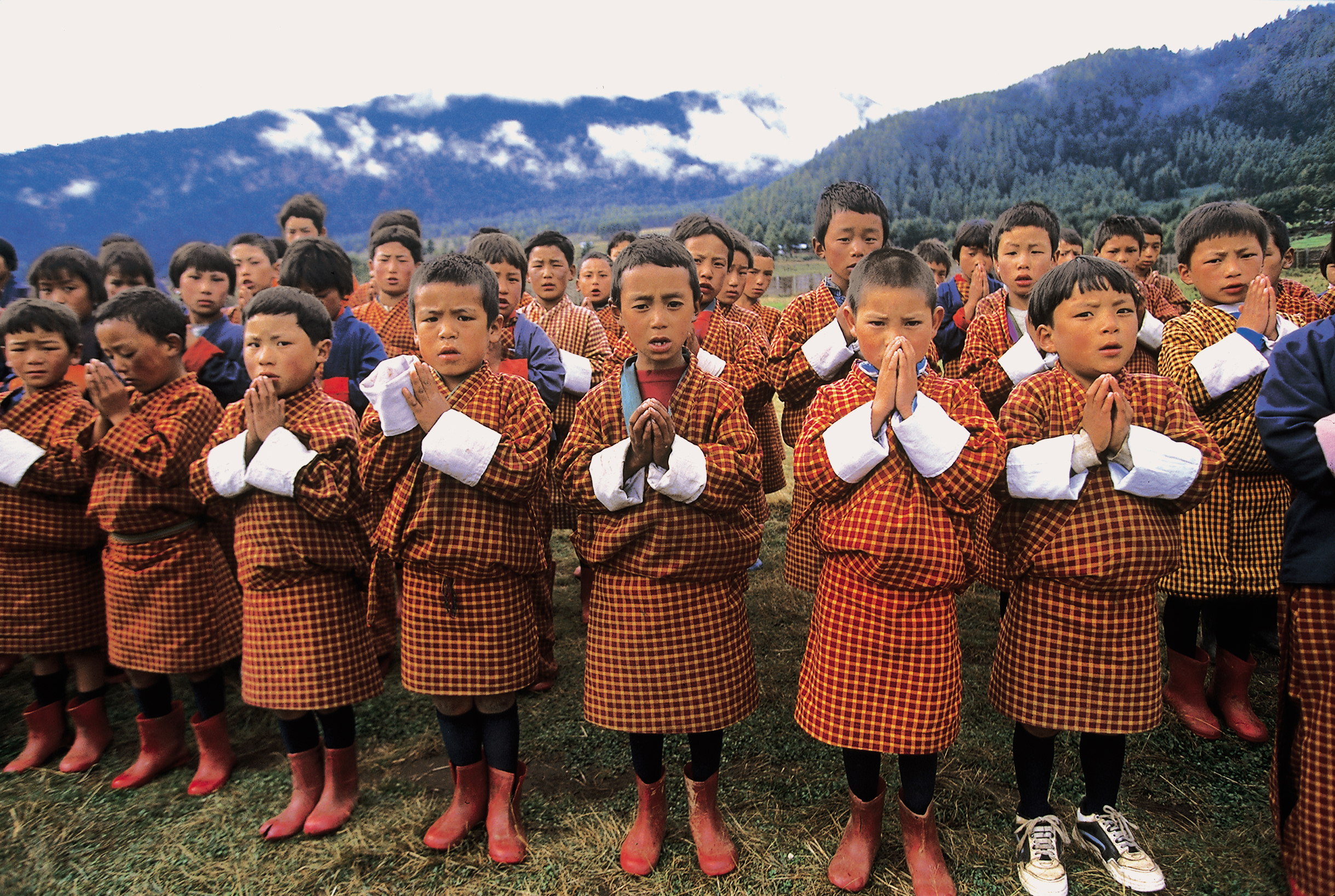 Schoolchildren performing morning prayers at school assembly in Bhutan. Schoolchildren performing morning prayers at school assembly in Bhutan.