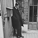 1957: Yves Saint Laurent, successor at Dior, standing alone after Christian Dior's funeral.