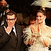2000: Yves Saint Laurent blows a kiss at the end of his Spring 2000 couture presentation, with bride Laetitia Casta standing by.