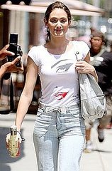 Emmy Rossum in LA Wearing a Message T-Shirt, Bow Belt, and Light Wash Jeans
