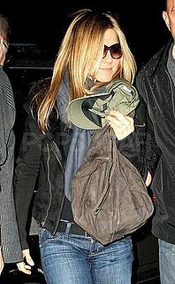 Hat Off, In Hands Instead For Jennifer Aniston