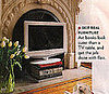 Glamour Magazine Suggests a Stack of Art Books as a Cheap, Alternative Flat Screen TV Stand