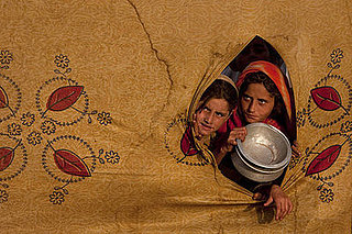 Displaced: Pakistani Girls Await Their Meals in Refugee Camp